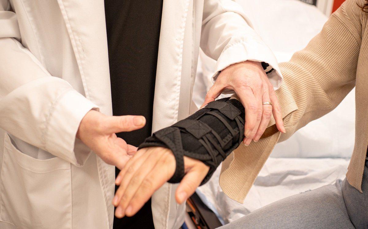 Medical provider examining wrist injury Medical provider putting a wrist splint on a child patient