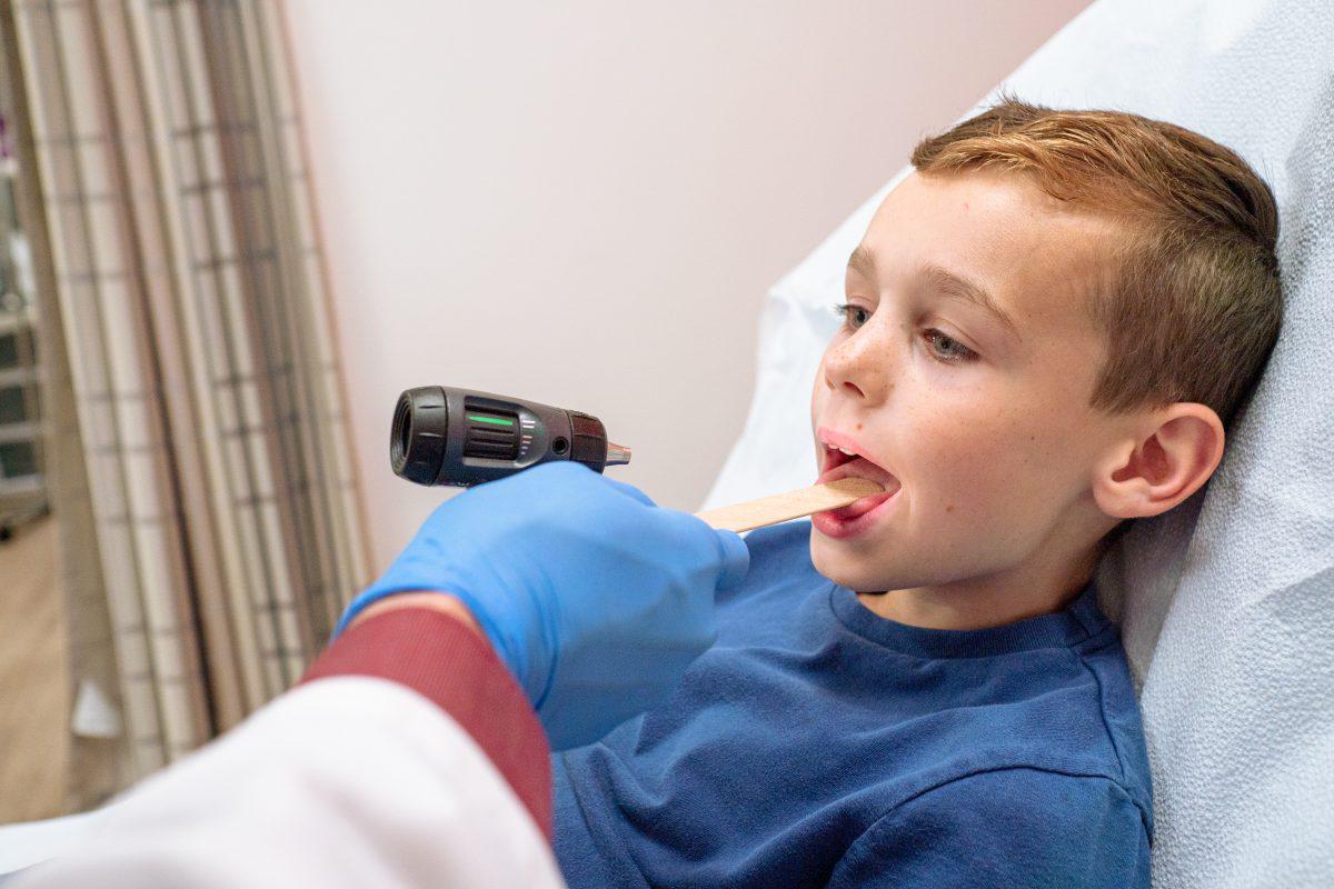 Child patient being examined for strep throat at AFC Huntersville