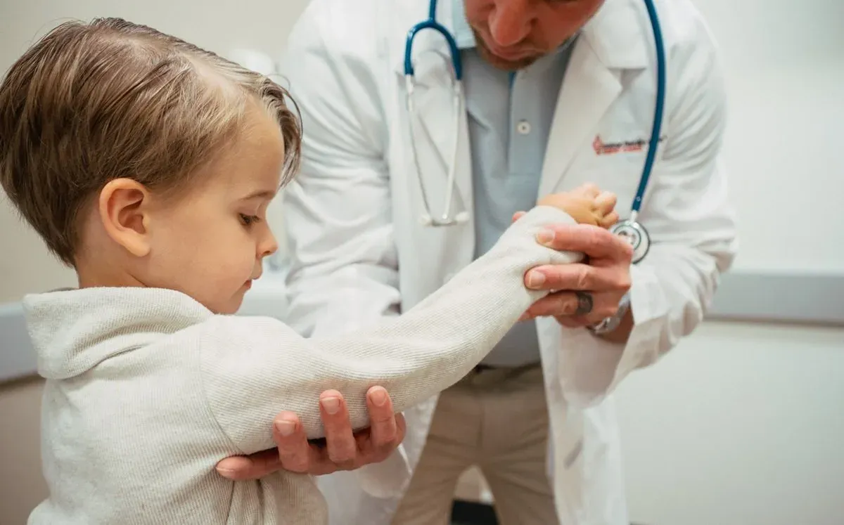 Medical provider treating nurse maid elbow on toddler