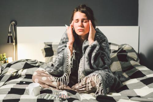 bedridden woman with sinus pain sitting down