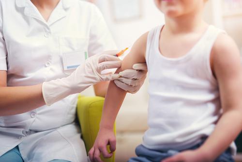 child receives MMR vaccine from physician