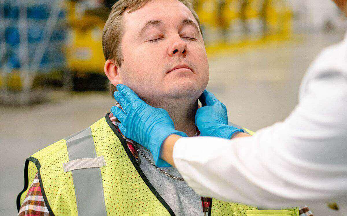 medical provider checking potential employee's glands