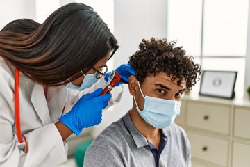 Young guy getting his ear checked by a provider at AFC Urgent Care Worcester