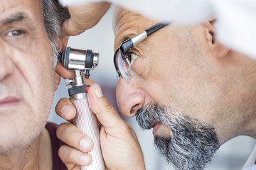 Old man getting his swimmer’s ear checked out by a provider at AFC Urgent Care Marlborough