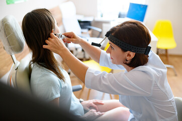 Woman getting her swimmer’s ear checked at AFC Urgent Care Vernon