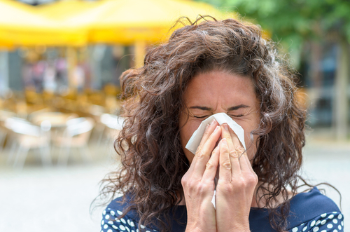 flu symptoms lead woman to sneeze