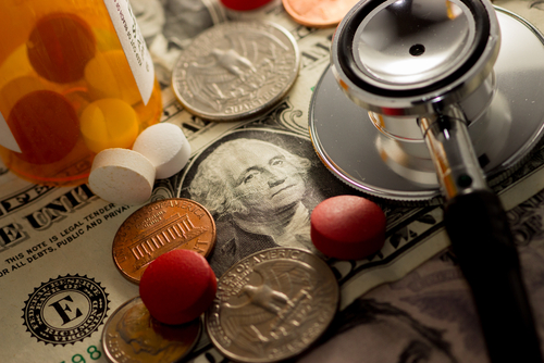 healthcare spending concept pennies and stethoscope