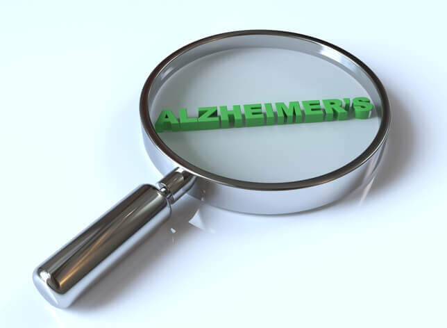 A magnifying glass focusing on the word "ALZHEIMER'S" in green text on a white background, emphasizing its importance in a medical context.