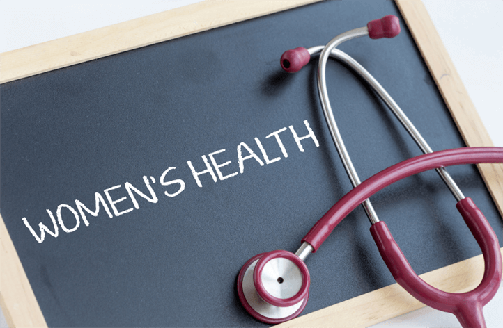 A blackboard with "Women's Health" written on it in white chalk, alongside a red stethoscope placed on the board, evoking the care and expertise found at a well-equipped medical center.