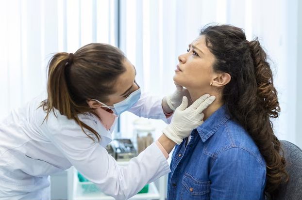 woman getting her throat checked