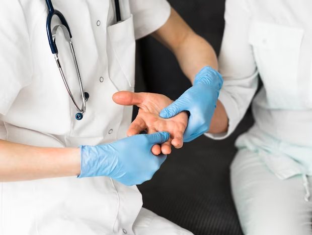 doctor checking palm of patient
