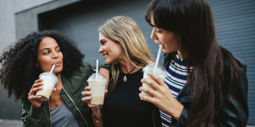 three women talking while having drinks