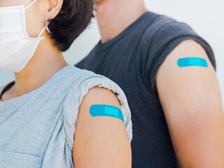 Two individuals with bandaids on their arms because they got vaccinated for the flu at AFC Urgent Care Norwalk
