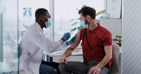 Provider at AFC Urgent Care West Hartford giving a male patient a flu shot to help protect against the flu this RSV and flu season