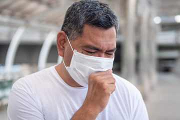 A man with a mask going to AFC Urgent Care West Springfield to find out the difference between strep throat and a sore throat caused by COVID-19