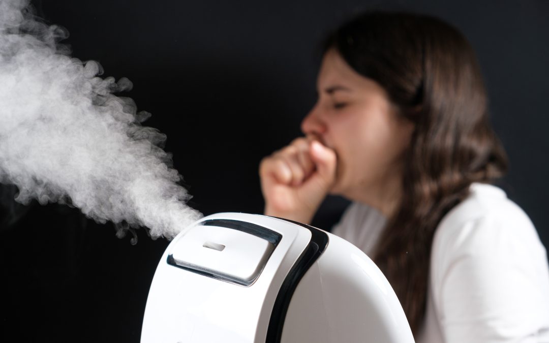 Humidifier and coughing woman in the background. Humidification of the air with cough and viral infections.