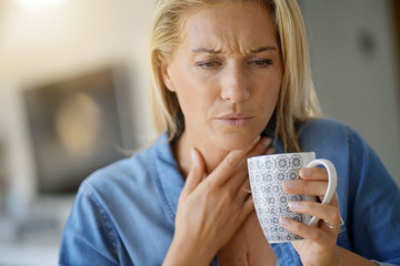 Woman feeling a sore throat and is wondering if it is strep throat at AFC Urgent Care Rocky Hill