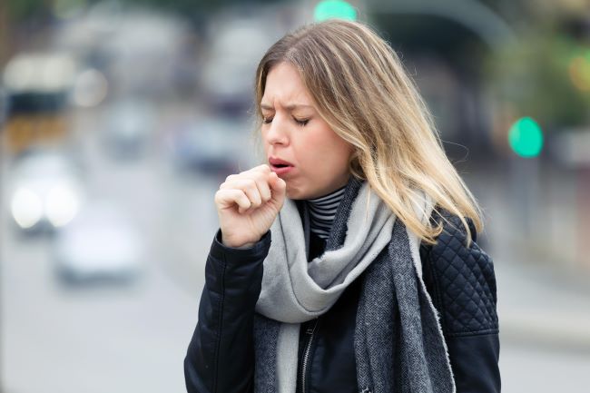 Picture of a woman bothered by a cough