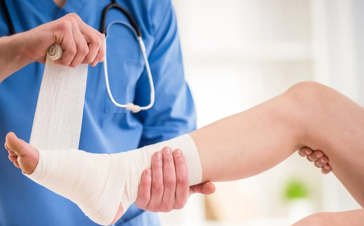medical provider wrapping patient's foot and ankle injury