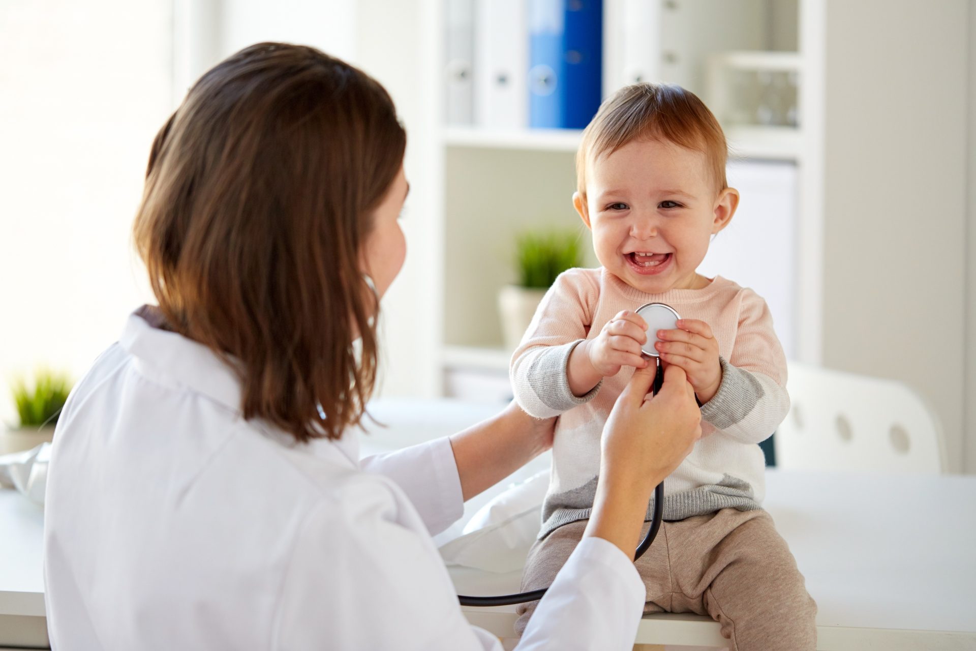 toddler with medical provider for pediatric urgent care services