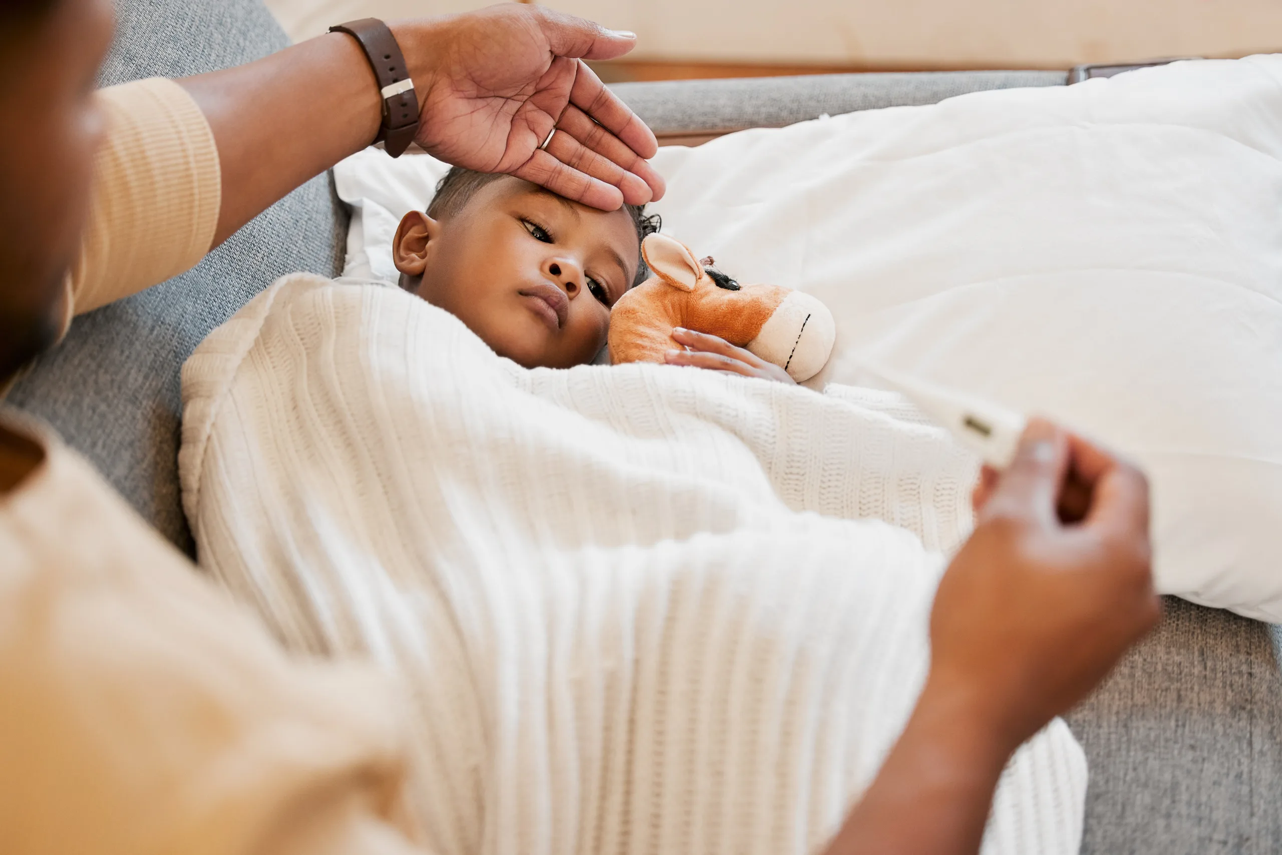 Father Checking Young Boy’s Temperature