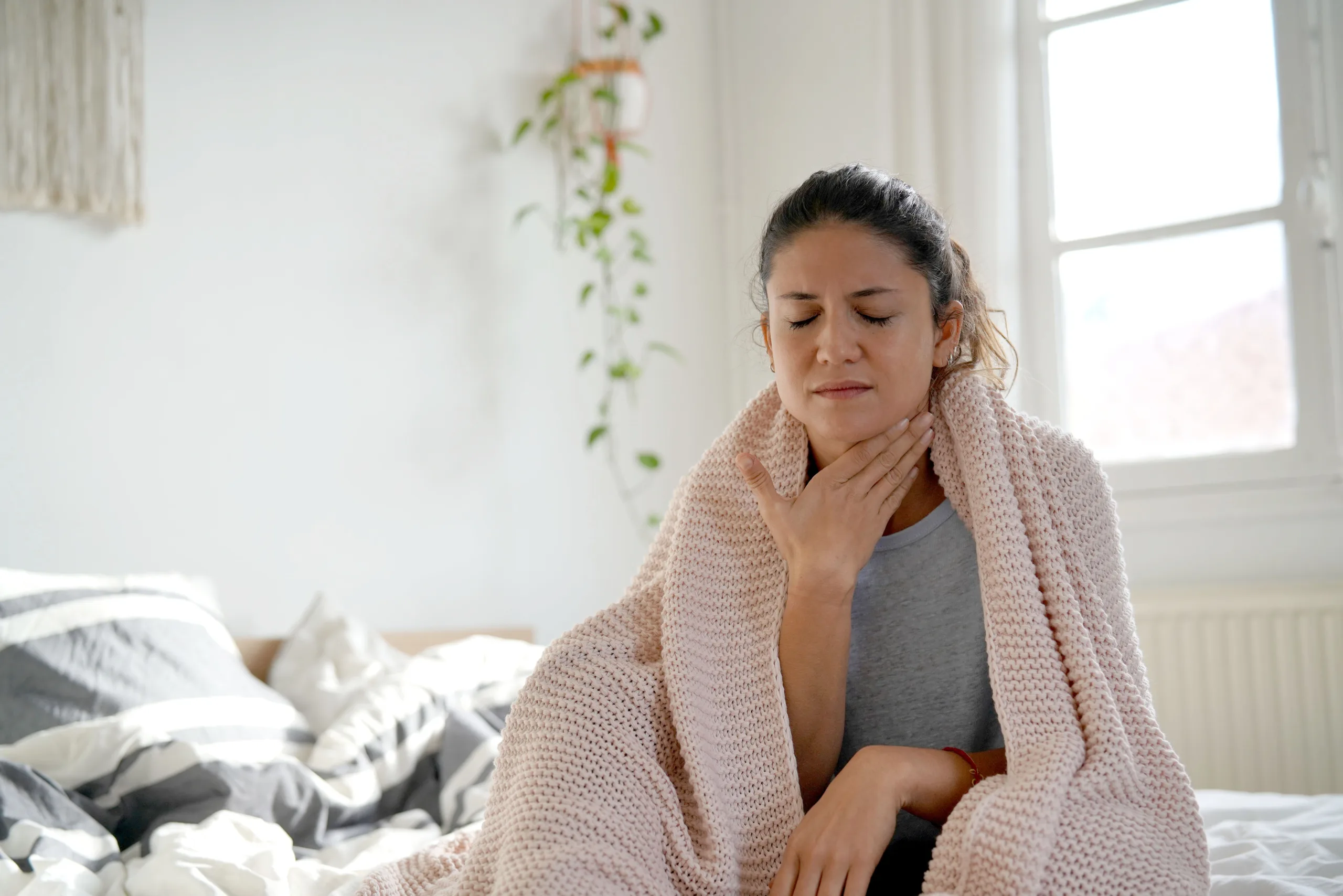 Woman Holding Throat in Pain