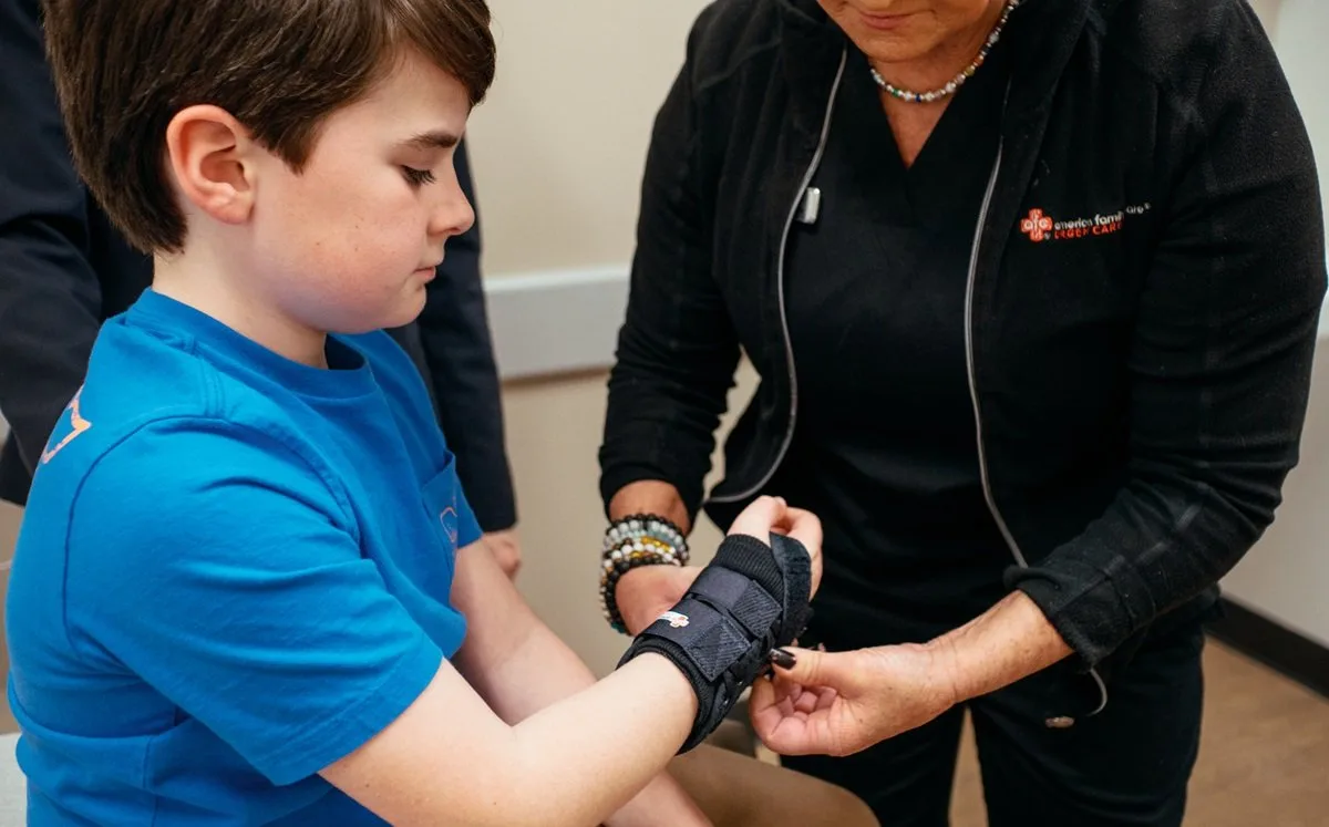 Medical provider putting a wrist splint on a child patient