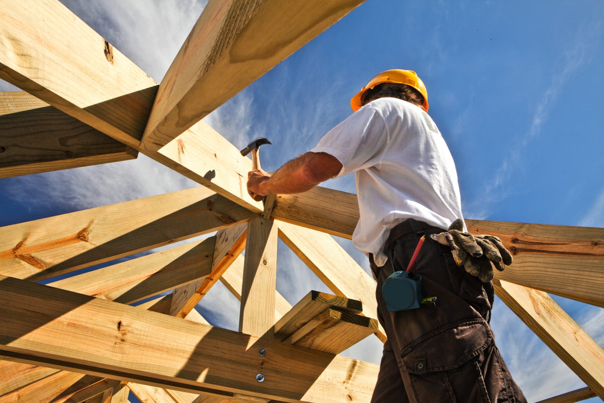 Construction worker nails boards with a hammer 