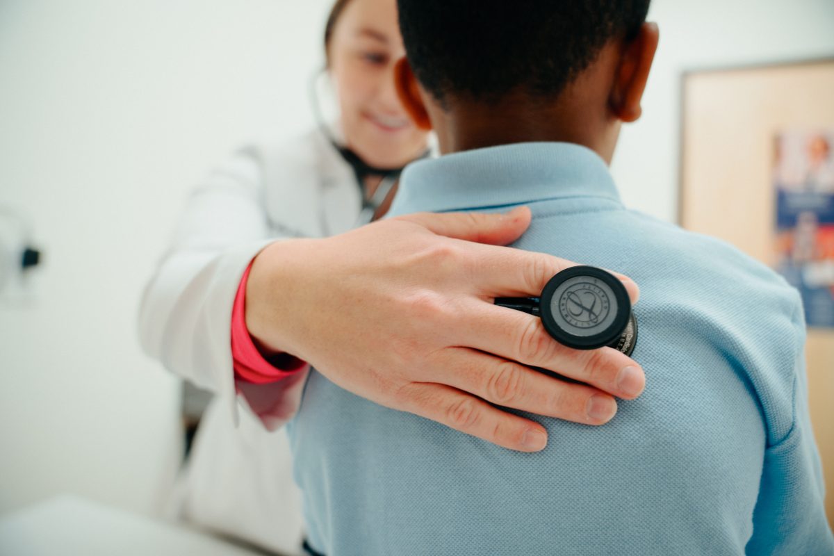 Doctor checking child at AFC during a sick visit