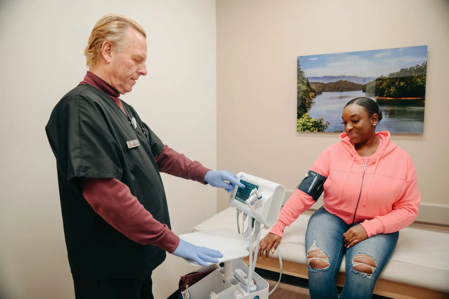 Medical professional taking a patient's blood pressure at a clinic